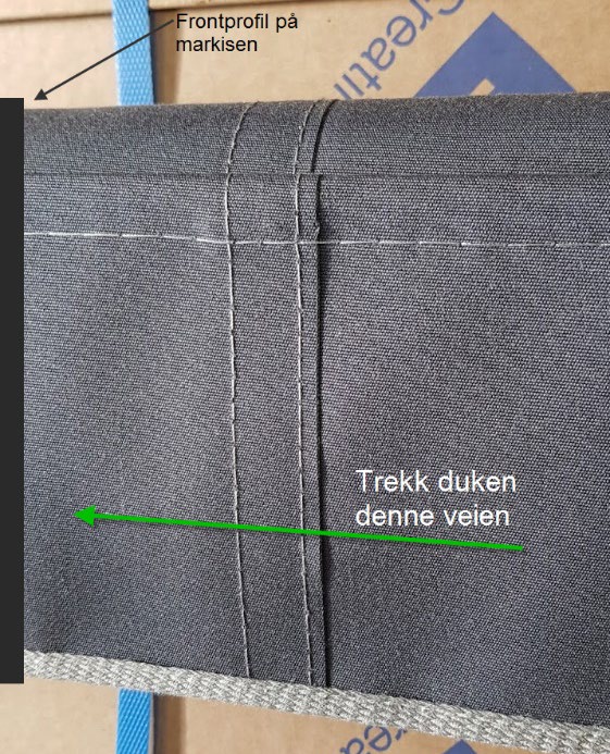Foto av markiseduk som trekkes inn i frontprofilen i riktig retning
